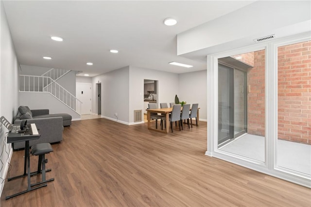 307 S Dithridge St Unit 207, Oakland, PA 15213 - living room with wood finished floors, stairway, and recessed lighting