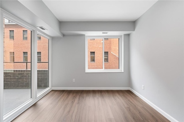 307 S Dithridge St Unit 207, Oakland, PA 15213 - empty room featuring wood finished floors and plenty of natural light