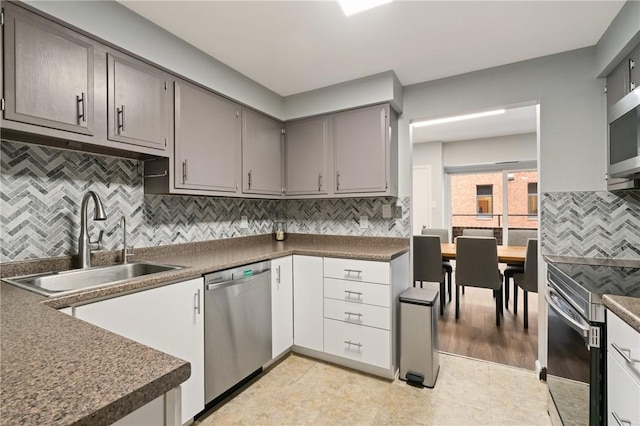 307 S Dithridge St Unit 207, Oakland, PA 15213 - kitchen featuring stainless steel appliances, dark countertops, backsplash, and gray cabinets