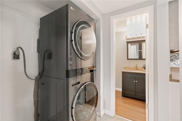 307 S Dithridge St Unit 207, Oakland, PA 15213 - laundry area featuring stacked washing machine and dryer and bar with sink