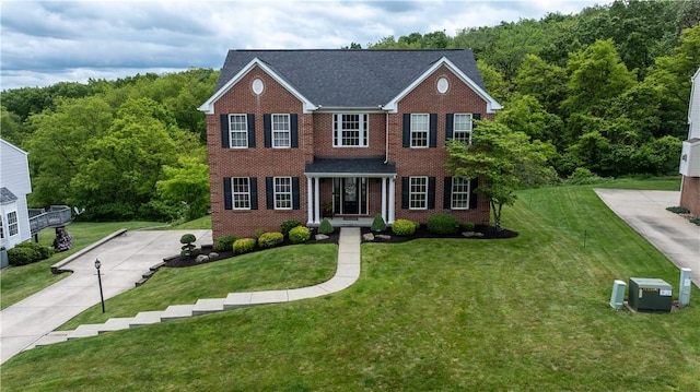 104 Cherokee Ct, Buffalo Twp But, PA 16229 - view of front of home with a front lawn, brick siding, and a wooded view