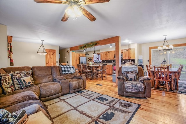 4627 Water Level Rd, Milford Twp, PA 15557 - living area featuring light wood-style flooring, ceiling fan, and a chandelier