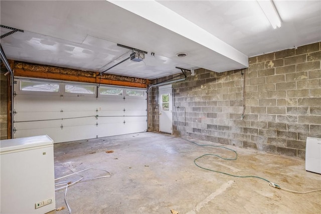 4627 Water Level Rd, Milford Twp, PA 15557 - garage with refrigerator, concrete block wall, and a garage door opener