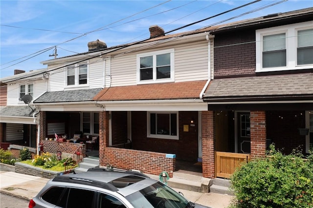 4207 Post St, Lawrenceville, PA 15201 - townhome / multi-family property with covered porch, brick siding, and a chimney