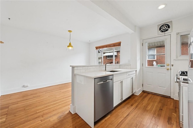 4207 Post St, Lawrenceville, PA 15201 - kitchen with dishwasher, light wood-style flooring, light countertops, white cabinets, and decorative light fixtures