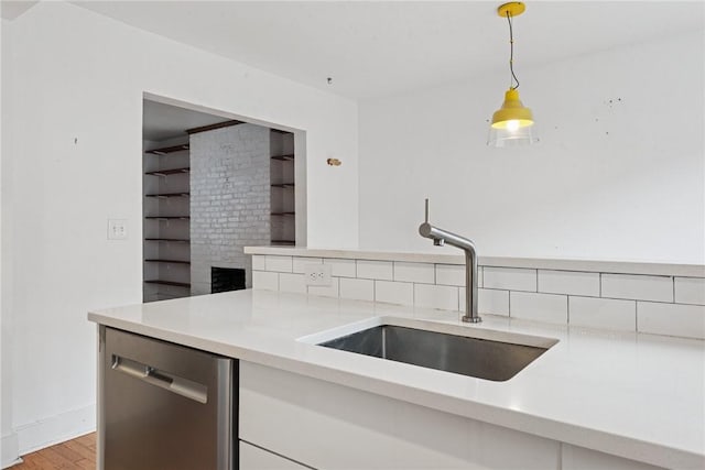 4207 Post St, Lawrenceville, PA 15201 - kitchen with dishwasher, light countertops, light wood-style floors, decorative light fixtures, and backsplash