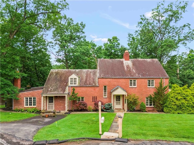 35 Redstone Ln, City Of Washington, PA 15301 - view of front of house with a chimney, brick siding, and a front yard