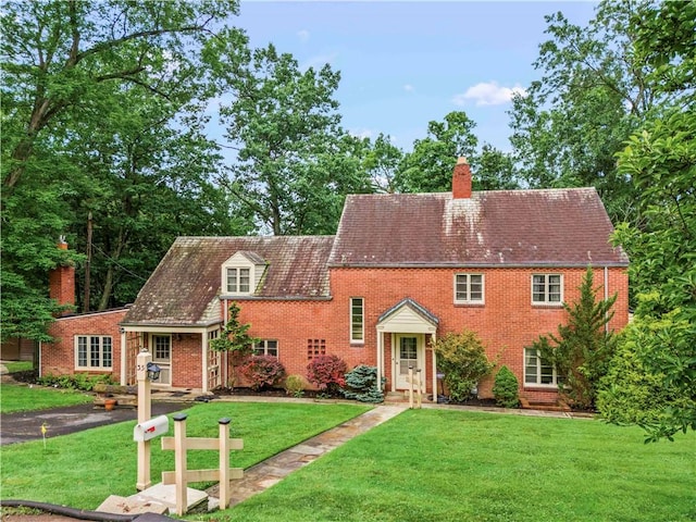 35 Redstone Ln, City Of Washington, PA 15301 - view of front facade featuring a chimney, a front yard, and brick siding