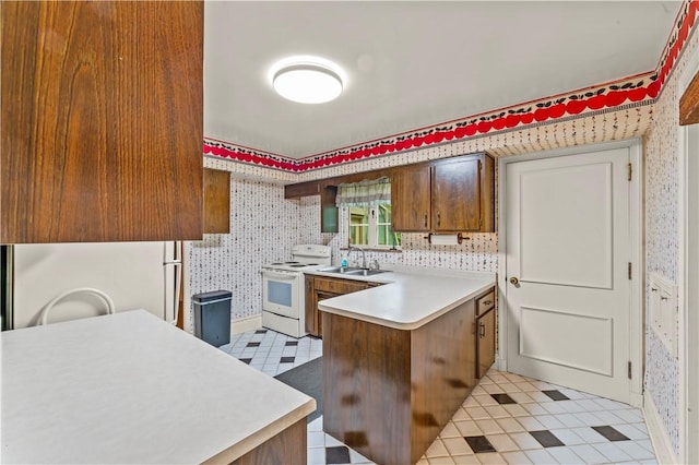 35 Redstone Ln, City Of Washington, PA 15301 - kitchen featuring white appliances, wallpapered walls, a peninsula, light countertops, and brown cabinetry