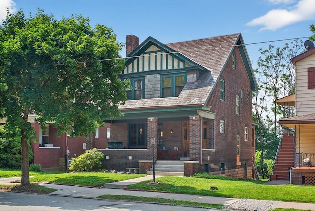 225 Waldorf St, Observatory Hill, PA 15214 - view of front of home with covered porch, a chimney, brick siding, and a front lawn