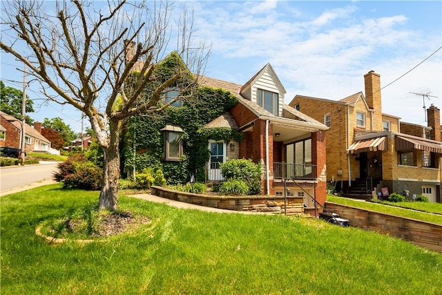 2401 Valera Ave, Carrick, PA 15210 - english style home with a front lawn, brick siding, and a porch