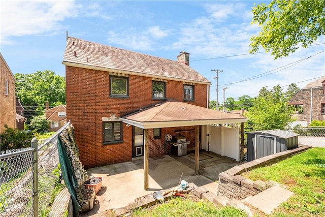 2401 Valera Ave, Carrick, PA 15210 - back of property with a chimney, brick siding, a patio, and a fenced backyard