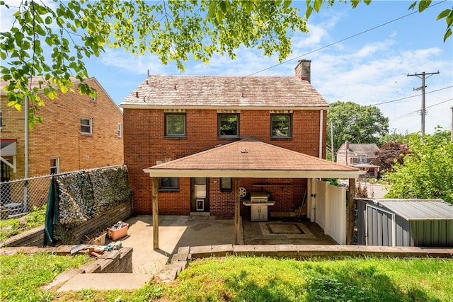 2401 Valera Ave, Carrick, PA 15210 - rear view of house featuring a chimney, a fenced backyard, a patio area, and brick siding