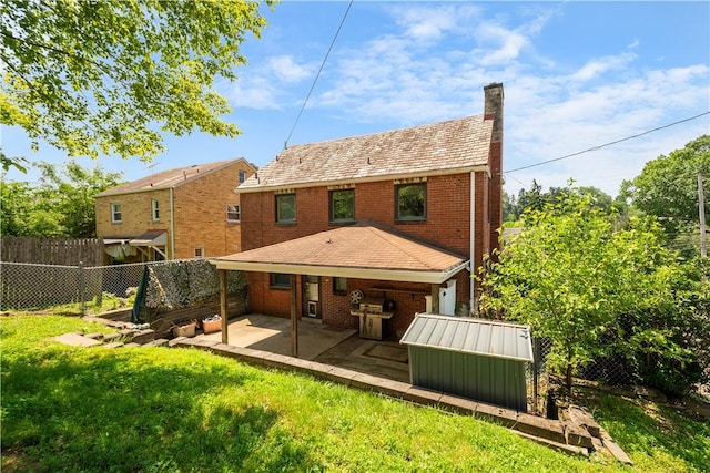 2401 Valera Ave, Carrick, PA 15210 - back of house featuring a fenced backyard, a storage shed, a chimney, and brick siding