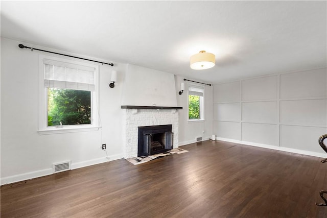 2401 Valera Ave, Carrick, PA 15210 - unfurnished living room with dark wood finished floors and a fireplace with flush hearth