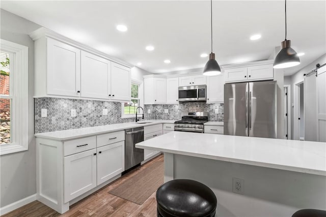 117 Heather Dr, Center Twp Bea, PA 15061 - kitchen with appliances with stainless steel finishes, dark wood-style floors, a breakfast bar area, light countertops, and recessed lighting