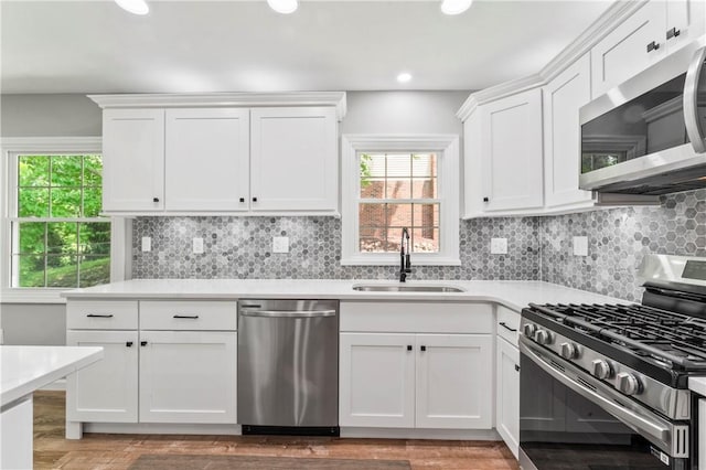 117 Heather Dr, Center Twp Bea, PA 15061 - kitchen featuring appliances with stainless steel finishes, light countertops, white cabinetry, wood finished floors, and recessed lighting
