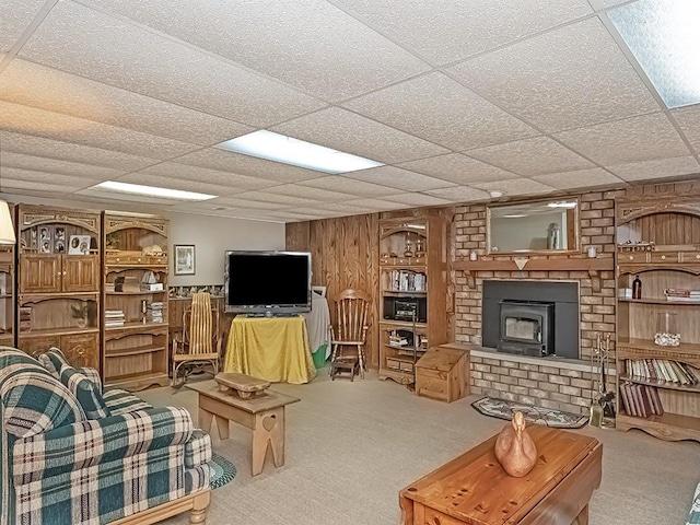 4779 State Route 819, Bell Twp, PA 15613 - living area featuring carpet floors, a drop ceiling, and a wood stove