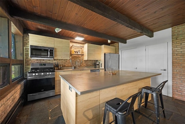 287 Rankin Rd, Belle Vernon, PA 15012 - kitchen featuring stainless steel appliances, stone tile floors, a kitchen island, a breakfast bar, and a wood ceiling with exposed beams