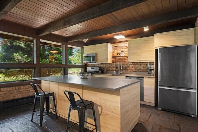 287 Rankin Rd, Belle Vernon, PA 15012 - kitchen featuring stainless steel appliances, stone tile flooring, modern cabinets, a kitchen island, and a wooden ceiling with exposed beams
