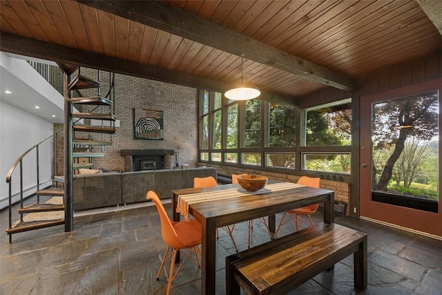 287 Rankin Rd, Belle Vernon, PA 15012 - dining area featuring stone tile floors, stairway, a fireplace, a wood ceiling with exposed beams, and a baseboard radiator