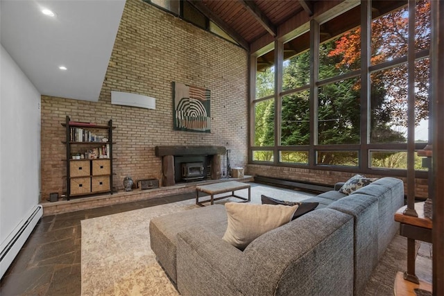 287 Rankin Rd, Belle Vernon, PA 15012 - living room with high vaulted ceiling, a baseboard heating unit, stone tile flooring, brick wall, and a wood stove