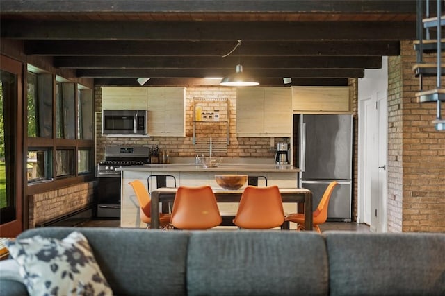 287 Rankin Rd, Belle Vernon, PA 15012 - kitchen featuring stainless steel appliances, brick wall, beam ceiling, light countertops, and hanging light fixtures