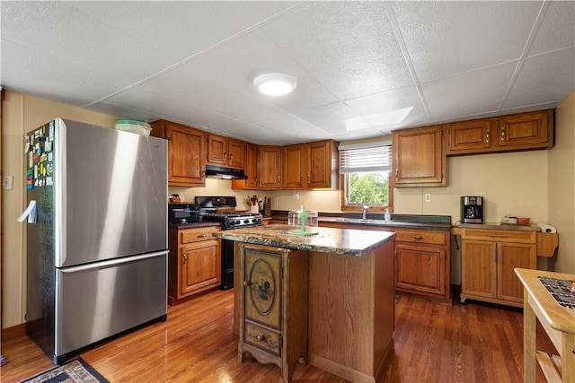 8 Leasure Way, Cecil, PA 15321 - kitchen featuring freestanding refrigerator, gas range, wood finished floors, and brown cabinets