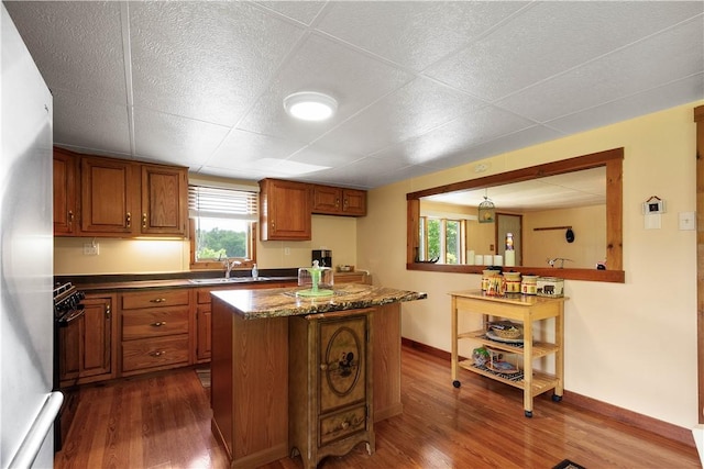 8 Leasure Way, Cecil, PA 15321 - kitchen featuring brown cabinetry, dark wood-style flooring, a center island, freestanding refrigerator, and a paneled ceiling