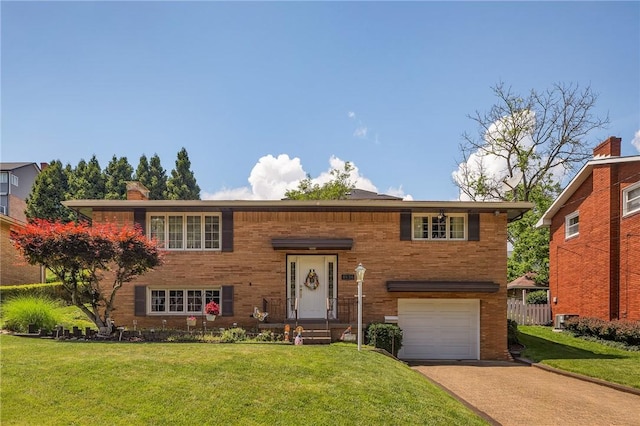 4636 Bowes Ave, West Mifflin, PA 15122 - bi-level home with an attached garage, a front yard, concrete driveway, and brick siding