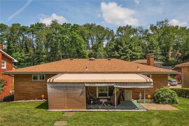 4636 Bowes Ave, West Mifflin, PA 15122 - back of property with a yard, brick siding, a patio area, roof with shingles, and a chimney