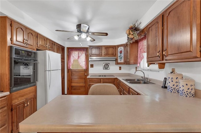 4636 Bowes Ave, West Mifflin, PA 15122 - kitchen with black appliances, under cabinet range hood, ceiling fan, and brown cabinets
