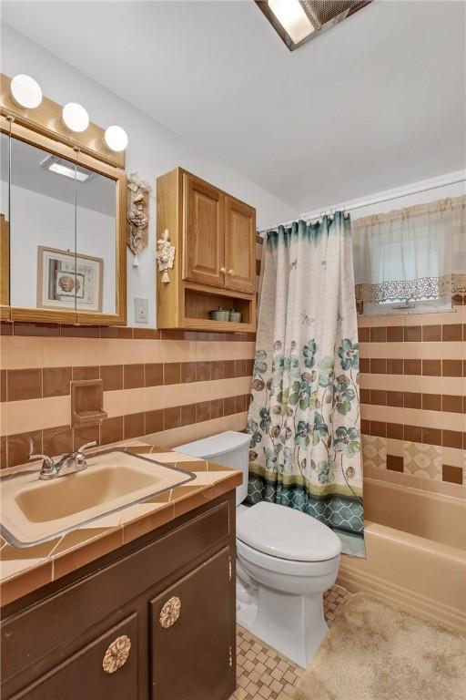 4636 Bowes Ave, West Mifflin, PA 15122 - bathroom with vanity, shower / tub combo with curtain, and tasteful backsplash