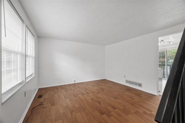 305 Laporte Ct, Cranberry Twp, PA 16066 - empty room featuring wood finished floors, track lighting, and a textured ceiling