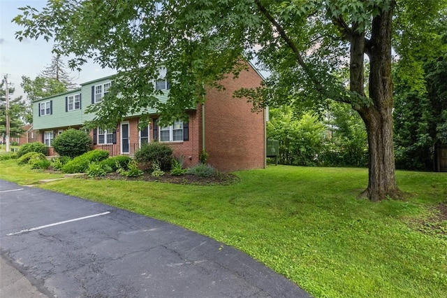 305 Laporte Ct, Cranberry Twp, PA 16066 - view of front facade with brick siding, a front lawn, and uncovered parking