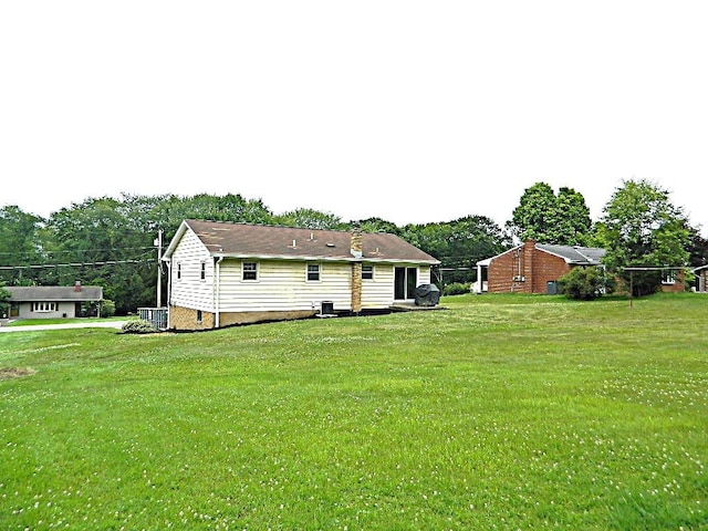 115 Lowery Dr, Middlesex Twp, PA 16059 - back of property with a yard and view of scattered trees