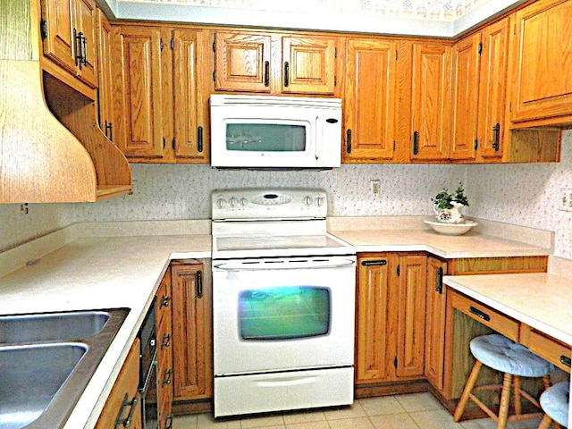 115 Lowery Dr, Middlesex Twp, PA 16059 - kitchen with white appliances, brown cabinets, light countertops, and light tile patterned flooring