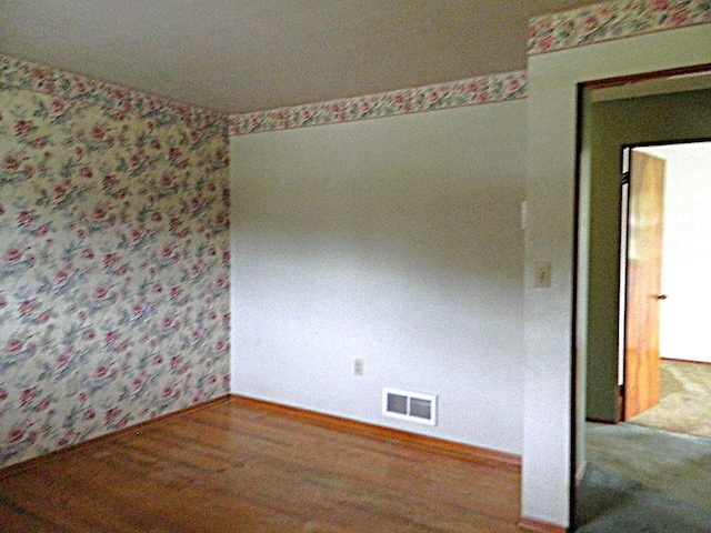 115 Lowery Dr, Middlesex Twp, PA 16059 - unfurnished room featuring wood finished floors and wallpapered walls