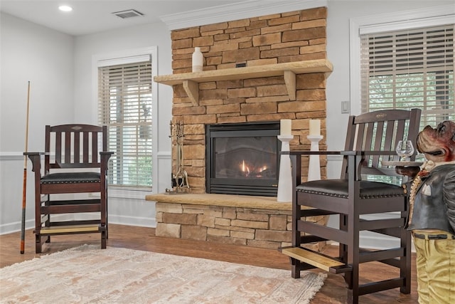 1011 Lakeside Dr, Mount Pleasant Twp Was, PA 15057 - living area with wood finished floors, a stone fireplace, and a wainscoted wall