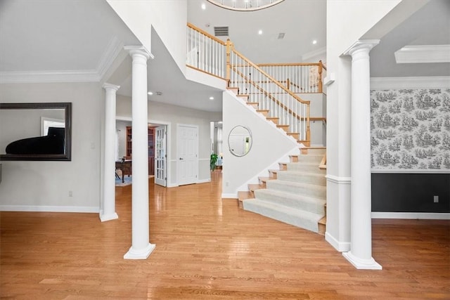 1011 Lakeside Dr, Mount Pleasant Twp Was, PA 15057 - entryway with stairs, wood finished floors, decorative columns, crown molding, and recessed lighting