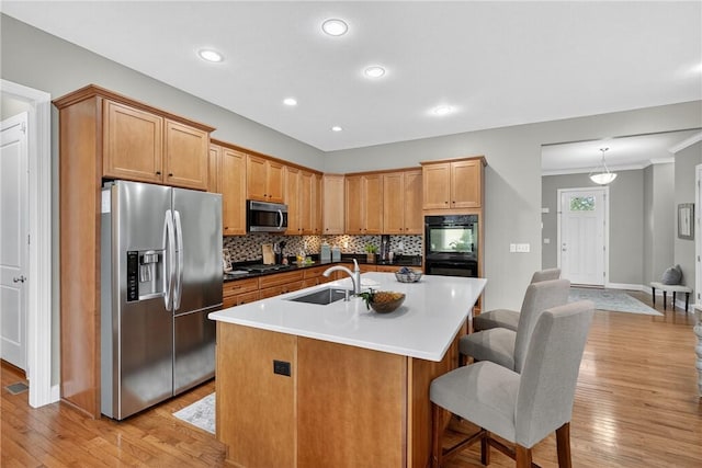 201 Venango Trl, Marshall, PA 16046 - kitchen featuring appliances with stainless steel finishes, light wood finished floors, tasteful backsplash, an island with sink, and recessed lighting