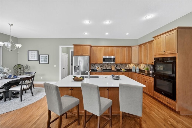 201 Venango Trl, Marshall, PA 16046 - kitchen featuring appliances with stainless steel finishes, light wood-style flooring, a chandelier, backsplash, and recessed lighting