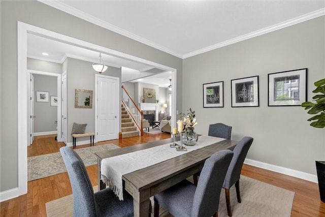 201 Venango Trl, Marshall, PA 16046 - dining space featuring wood finished floors, crown molding, and stairway