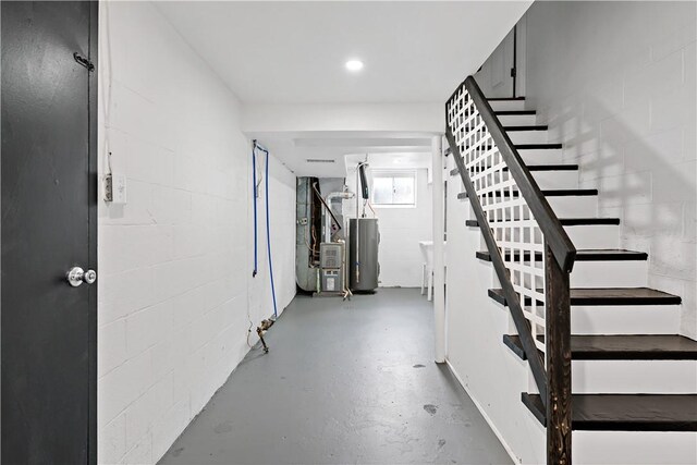 103 Church Ave, Mount Oliver, PA 15210 - staircase with water heater, concrete floors, and concrete block wall