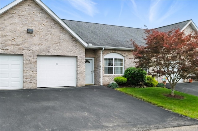 31 Elena Ave, Lower Burrell, PA 15068 - view of front facade with asphalt driveway, a shingled roof, brick siding, and a garage