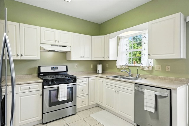 31 Elena Ave, Lower Burrell, PA 15068 - kitchen with stainless steel appliances, under cabinet range hood, white cabinets, light countertops, and light tile patterned floors