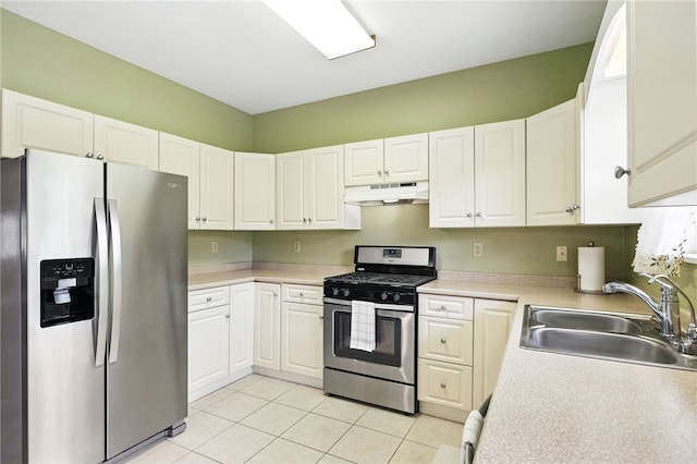 31 Elena Ave, Lower Burrell, PA 15068 - kitchen featuring stainless steel appliances, under cabinet range hood, light tile patterned floors, and white cabinets