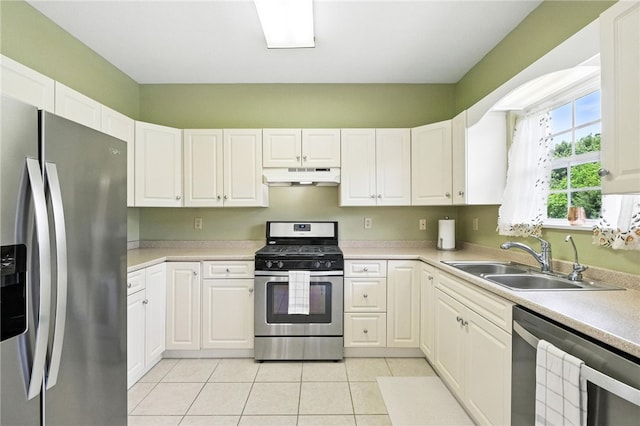 31 Elena Ave, Lower Burrell, PA 15068 - kitchen featuring stainless steel appliances, under cabinet range hood, light tile patterned flooring, and white cabinetry