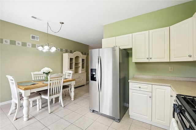 31 Elena Ave, Lower Burrell, PA 15068 - kitchen featuring stainless steel fridge with ice dispenser, gas range, light countertops, and white cabinetry