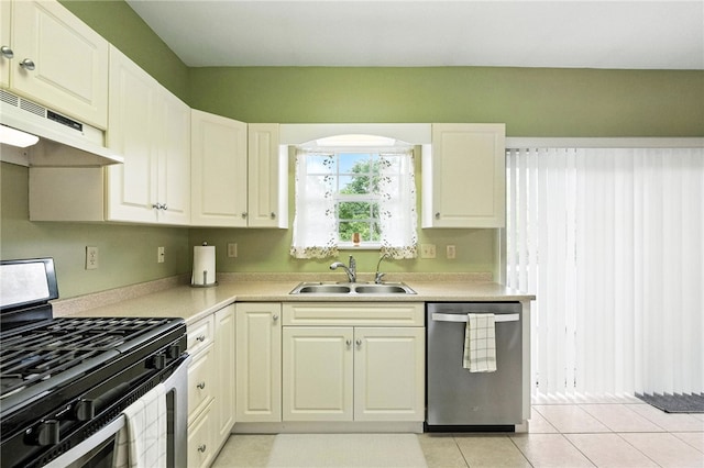 31 Elena Ave, Lower Burrell, PA 15068 - kitchen with stainless steel appliances, under cabinet range hood, light countertops, light tile patterned floors, and white cabinets